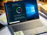 DALL·E 2023-10-27 04.24.15 - Photo of a workspace featuring a Windows 10 laptop, showing a progress bar for the 22H2 update. On the desk, there are scattered documents about the r